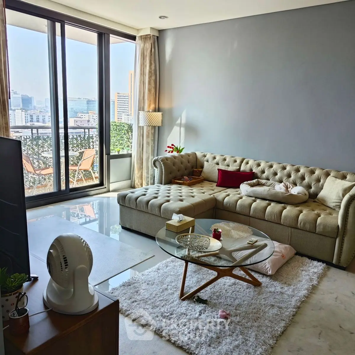 Luxurious living room with modern decor and stunning city view from large windows.