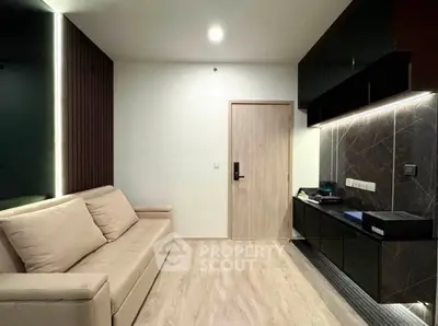 Modern living room with sleek design and stylish furniture, featuring a comfortable sofa and elegant cabinetry.