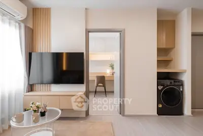 Modern living room with wall-mounted TV and adjacent study area