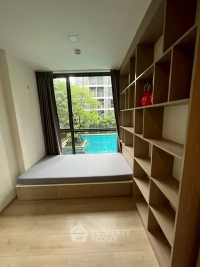 Modern room with built-in shelving and pool view, perfect for relaxation and storage.