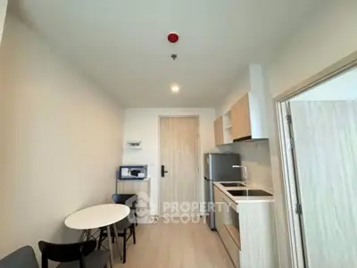 Modern compact kitchen with dining area in a stylish apartment