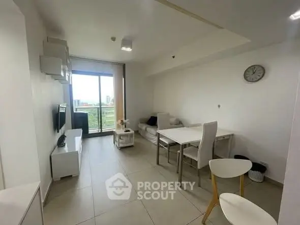 Modern living room with sleek furniture and balcony view