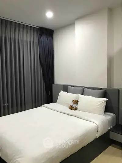 Modern bedroom with cozy bed and elegant curtains