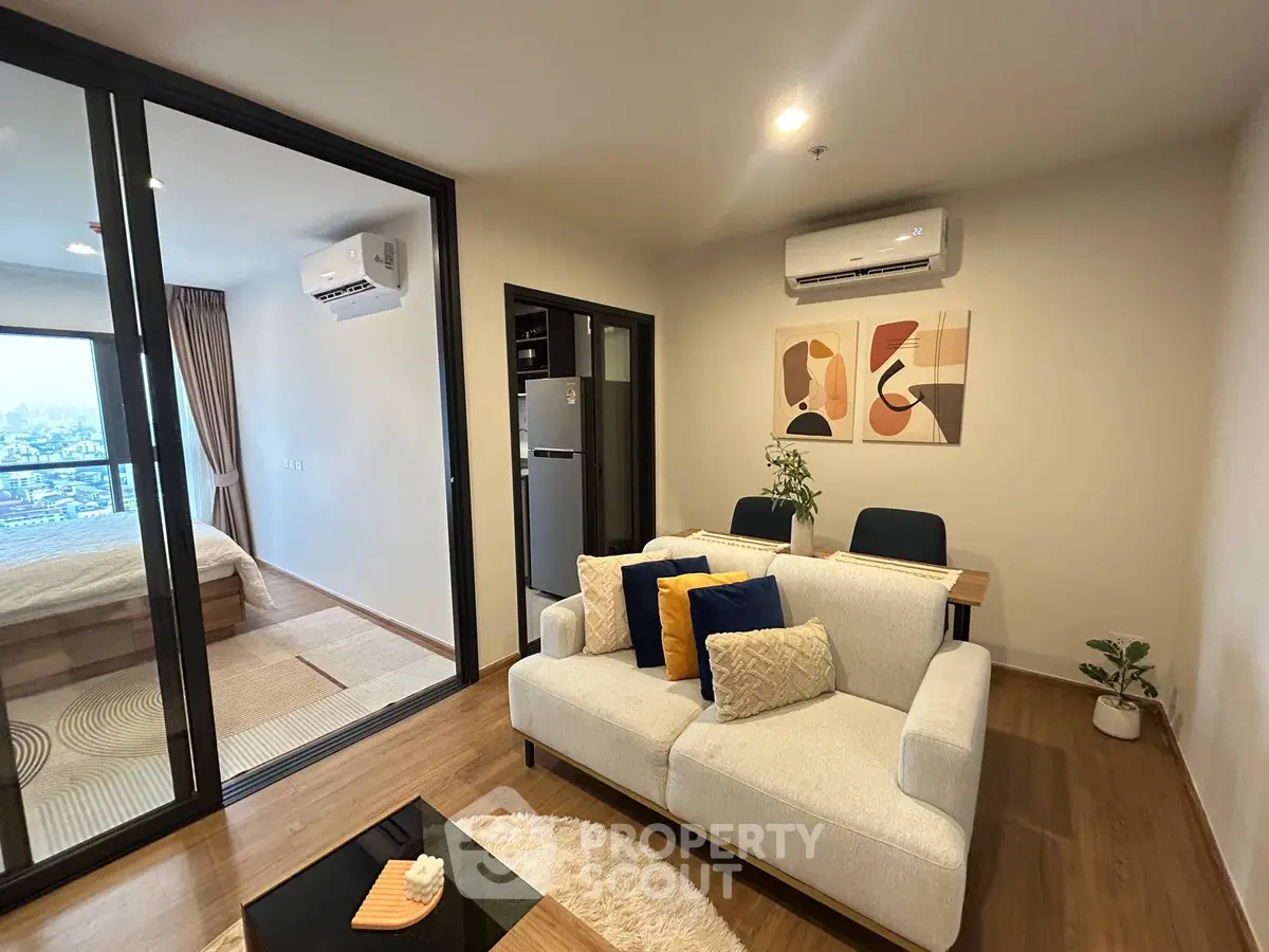 Modern living room with open layout, stylish decor, and balcony view in a contemporary apartment.