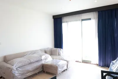 Spacious living room with modern furniture and large windows for natural light.