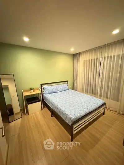 Cozy bedroom with modern decor and ample natural light