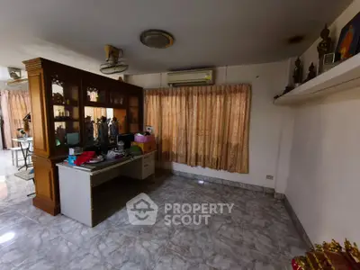 Spacious living room with marble flooring and large windows for natural light