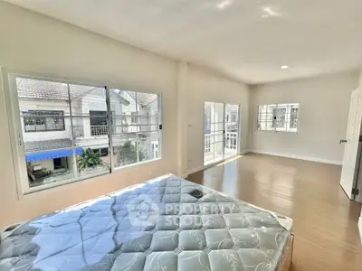 Spacious bedroom with large windows and natural light in modern home