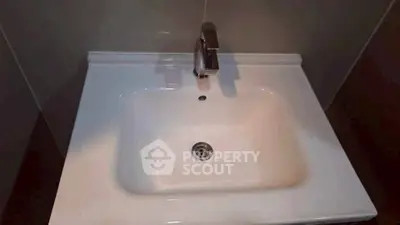 Modern bathroom sink with sleek faucet in contemporary setting.