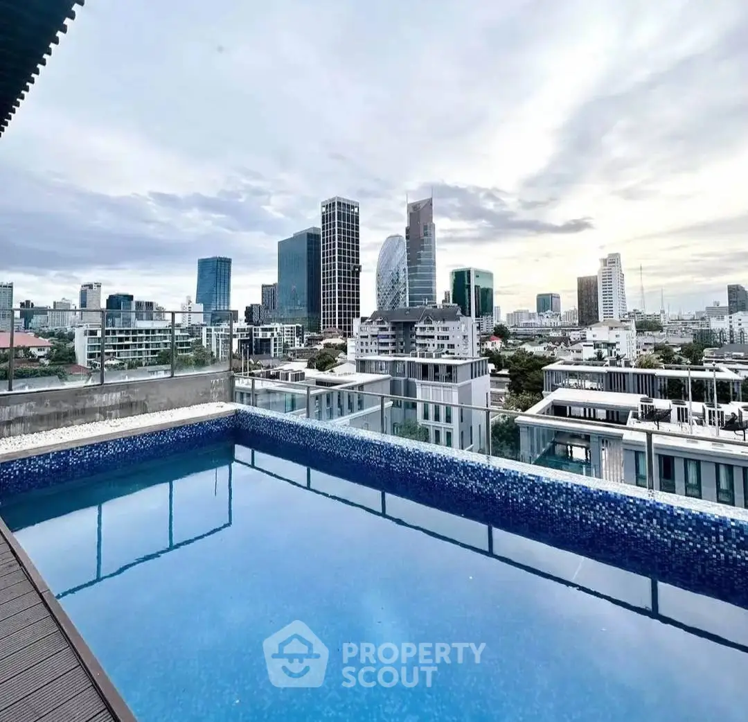 Stunning rooftop pool with panoramic city skyline views, perfect for luxury urban living.