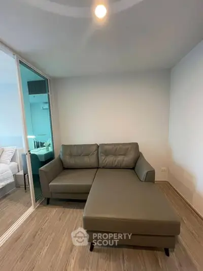 Modern living room with sleek sectional sofa and wooden flooring