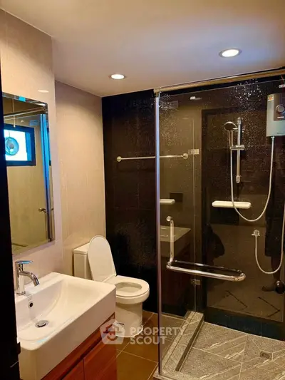 Modern bathroom with glass shower enclosure and sleek fixtures