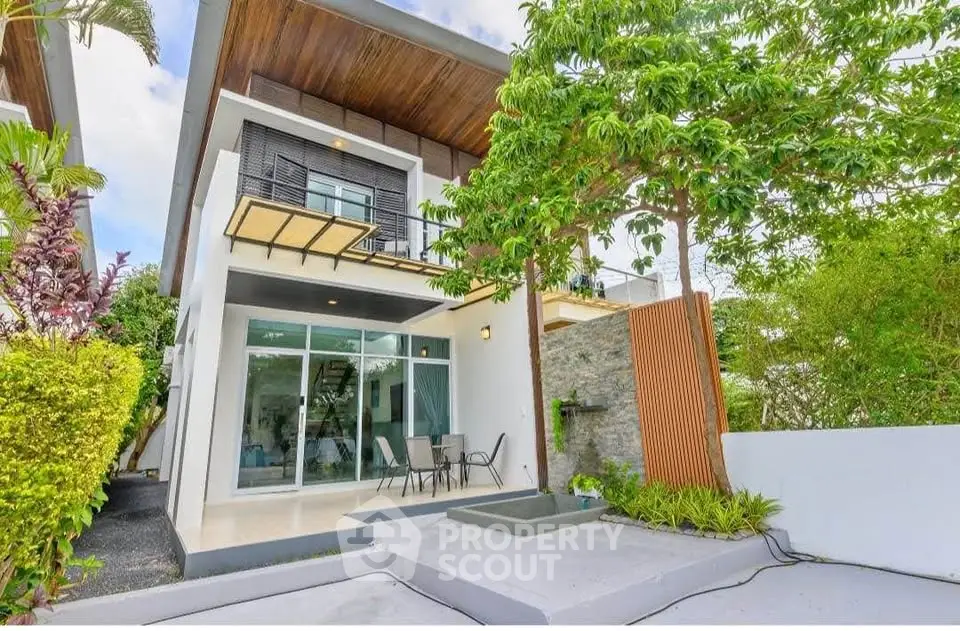 Modern two-story house with lush garden and spacious patio