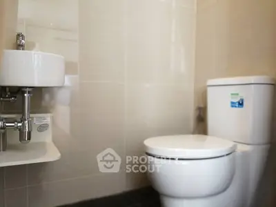 Modern bathroom with sleek fixtures and neutral tiles
