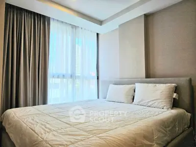 Cozy bedroom with large window and modern decor in a stylish apartment