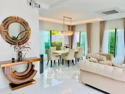 Luxurious living room with elegant dining area, plush sofas, and modern decor in a bright, airy space.