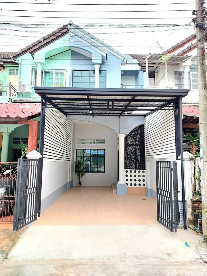 Charming townhouse with gated entrance and covered parking in a serene neighborhood.