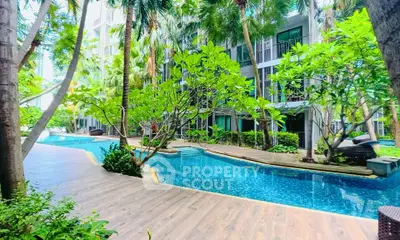 Luxurious condo with tropical pool and lush garden surroundings, perfect for relaxation and leisure.