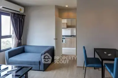 Modern living room with blue sofa and dining area in open layout apartment