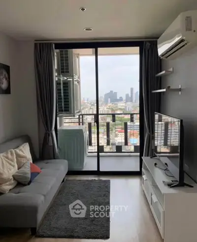 Modern living room with balcony and city view, featuring sleek furniture and air conditioning.