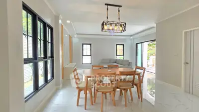 Spacious modern dining area with elegant lighting and large windows