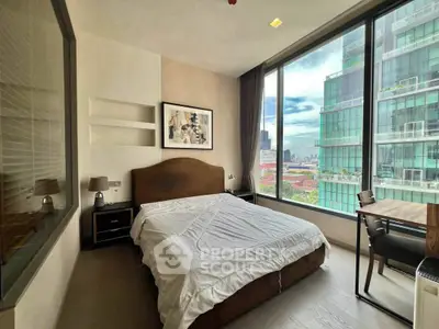 Modern bedroom with large windows offering stunning city views in a high-rise apartment.