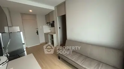 Modern compact living room with kitchenette and sleek design