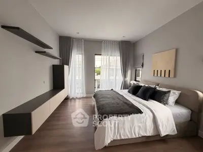 Modern bedroom with stylish decor and large window for natural light