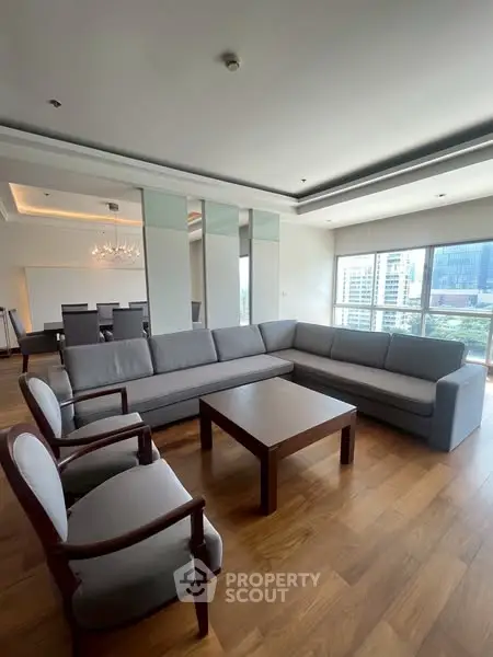 Spacious modern living room with large windows and elegant furniture