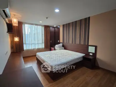 Spacious bedroom with modern design and large window for natural light