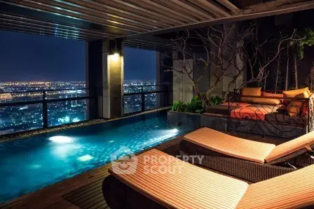 Luxurious rooftop pool with stunning city view at night, perfect for relaxation and entertainment.
