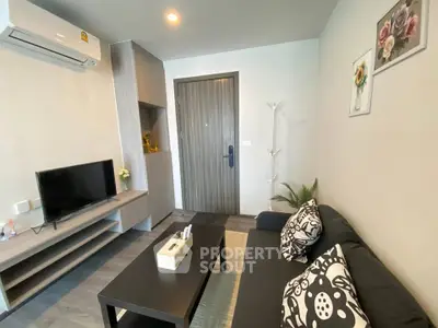 Modern living room with stylish decor and cozy seating area, perfect for relaxation.