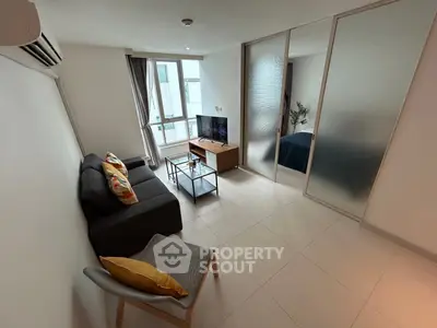 Modern living room with sleek design and cozy furniture in a bright apartment.