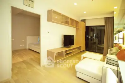 Modern living room with sleek wooden furniture and large window offering city view.