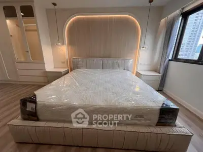 Luxurious bedroom with modern lighting and large window view