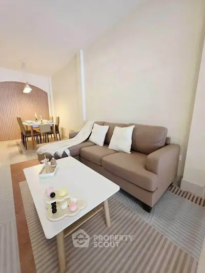 Stylish living room with cozy sofa and modern dining area