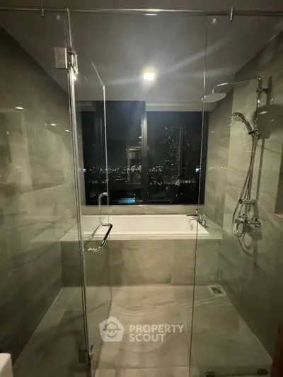 Luxurious bathroom with glass shower and city view from bathtub