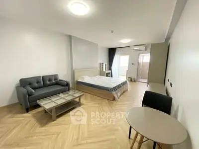 Spacious modern studio apartment with stylish furniture and natural light.