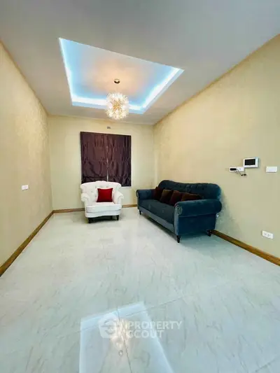 Elegant living room with modern lighting and plush seating, perfect for relaxation and entertaining.