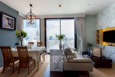 Luxurious living room with stunning city view, elegant decor, and modern furnishings in high-rise apartment.