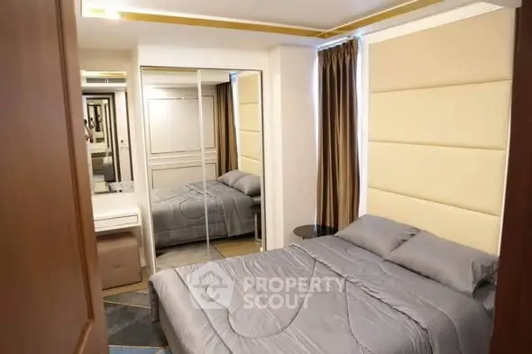 Modern bedroom with mirrored closet and elegant decor