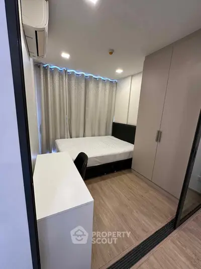 Modern bedroom with sleek design, featuring a comfortable bed, built-in wardrobe, and stylish desk.