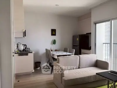 Modern open-layout living room with dining area and balcony access