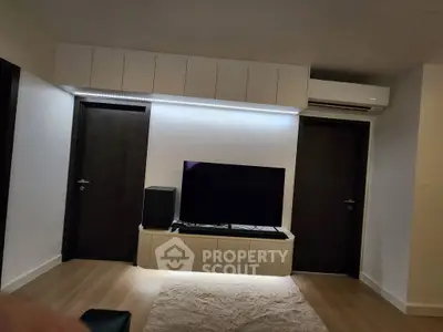 Modern living room with sleek TV setup and stylish lighting