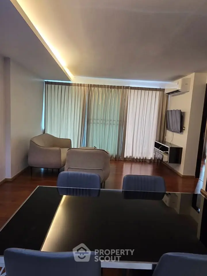 Spacious modern living room with elegant furniture and large windows for natural light.