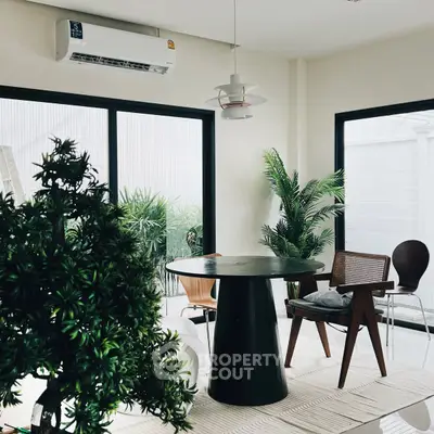 Stylish modern living room with chic furniture and lush greenery