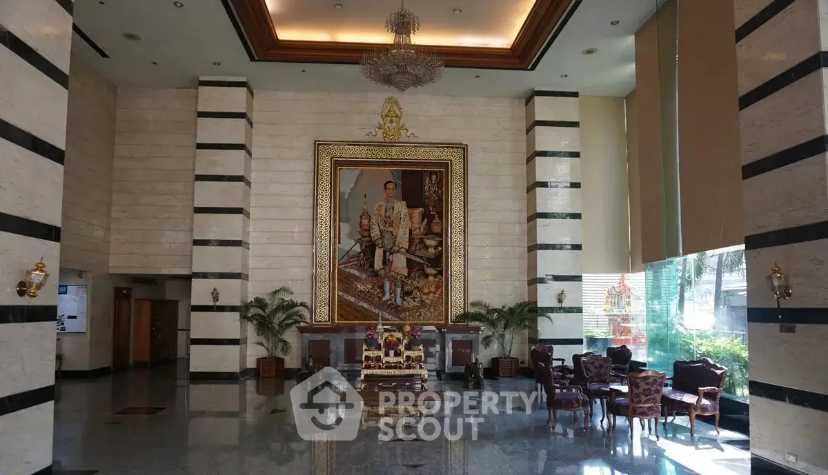 Luxurious building entrance with grand portrait and elegant seating area