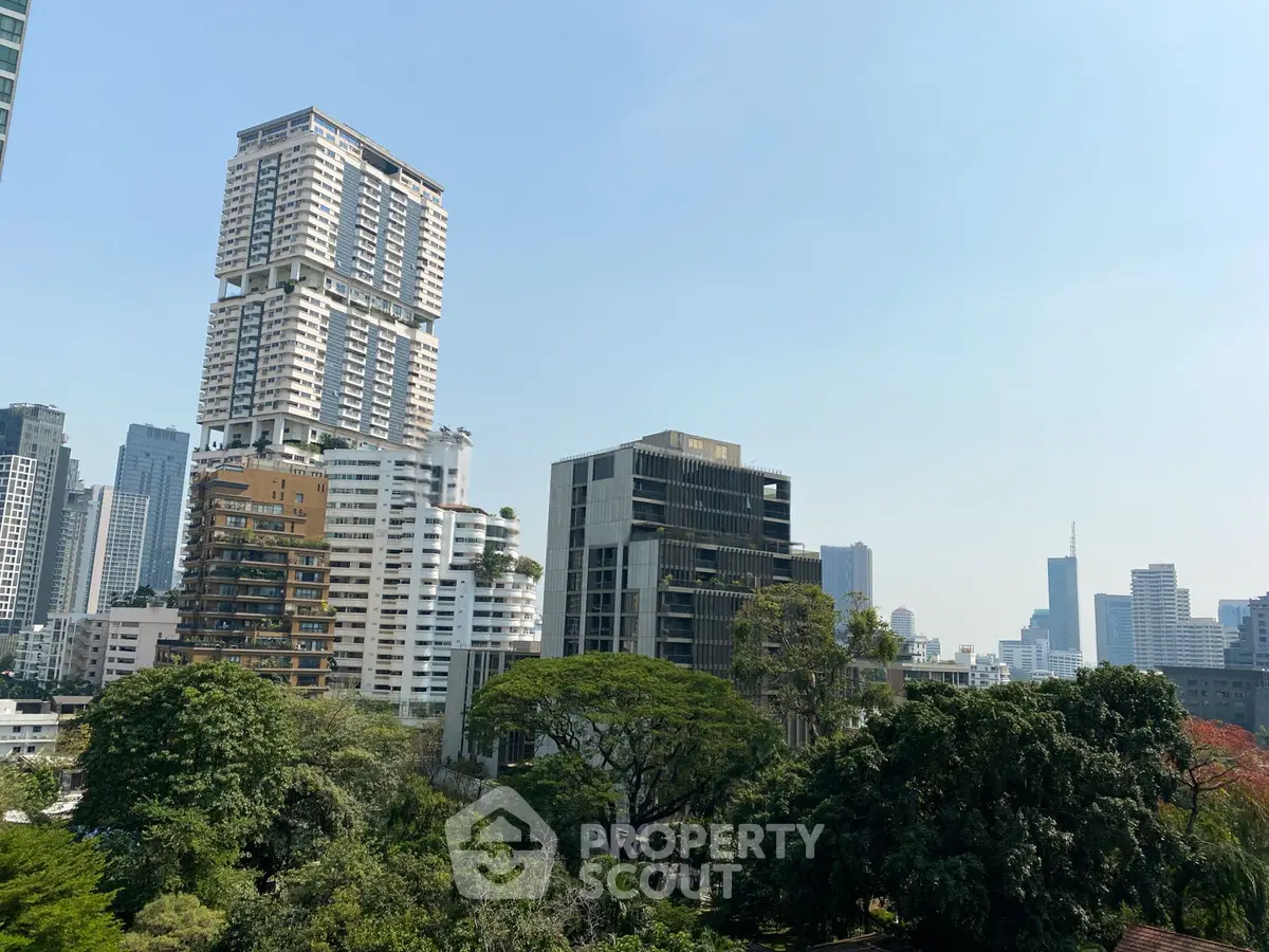 Stunning cityscape view with modern high-rise buildings and lush greenery, perfect for urban living.