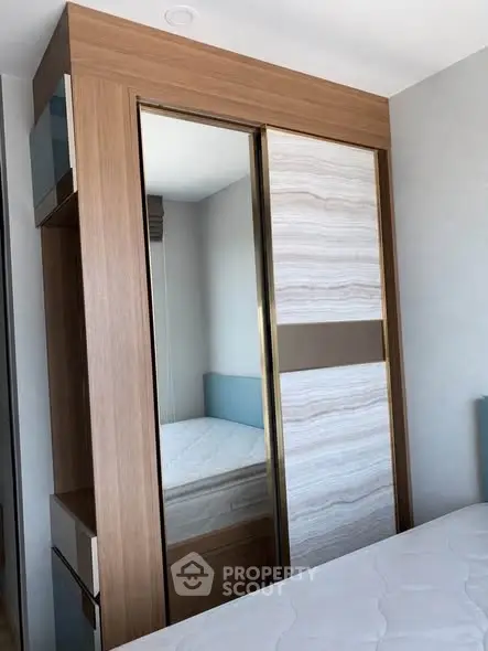 Modern bedroom with stylish wardrobe and comfortable bed