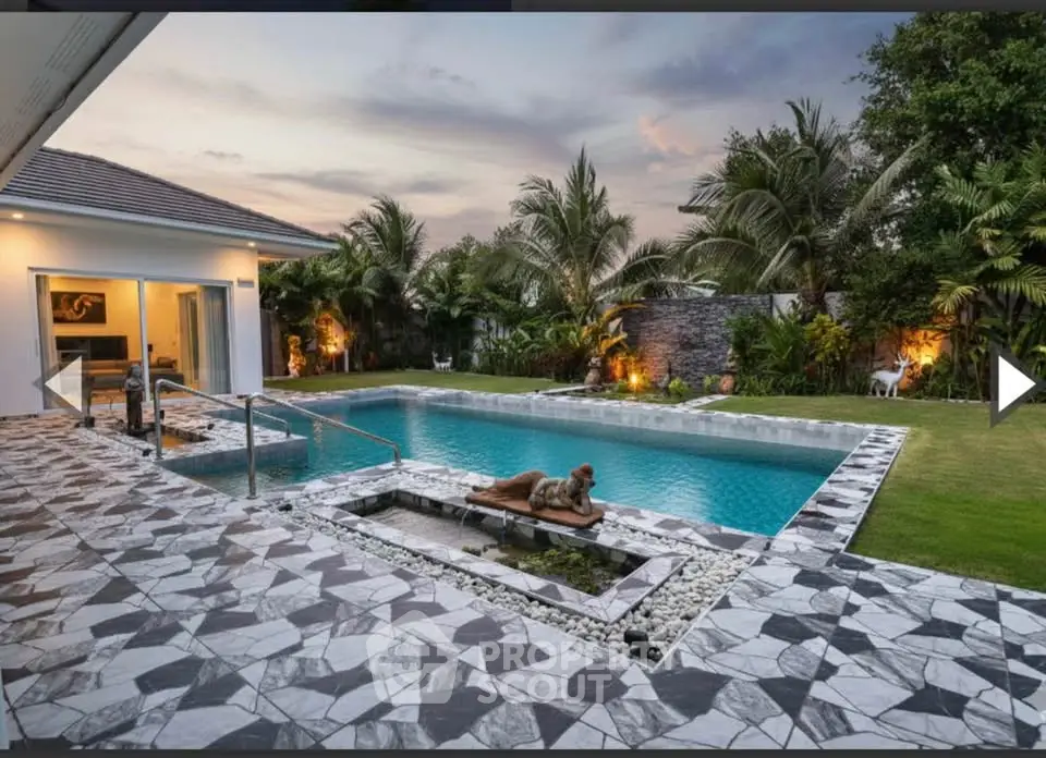 Luxurious villa with stunning pool and lush garden at sunset, perfect for relaxation and entertainment.